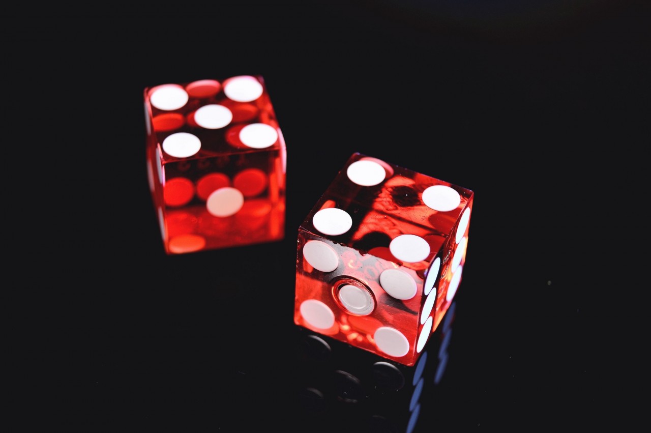 Two red dice on black background
