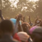 People dancing with hands upstretched
