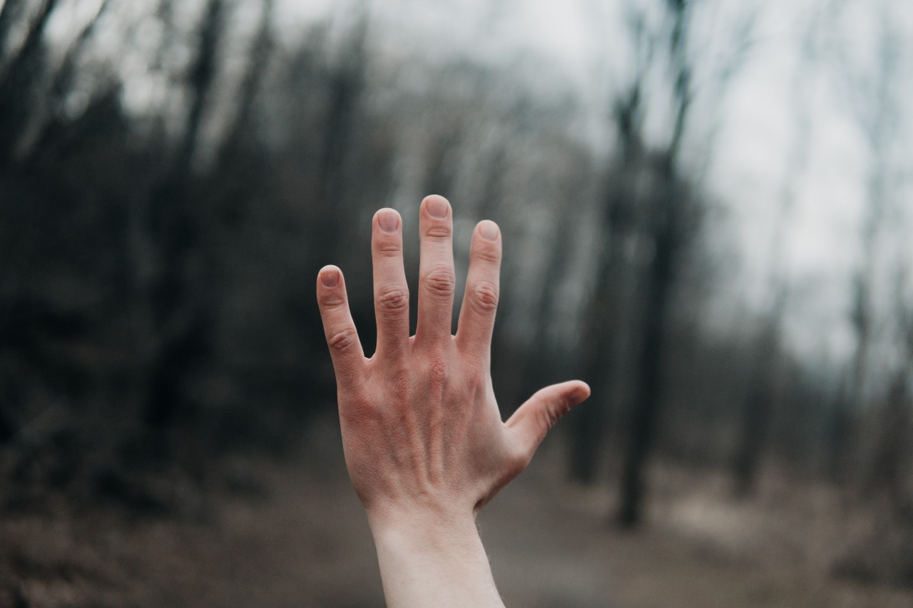 Hand outstretched on a winters day