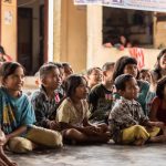Group of children, sat on the ground