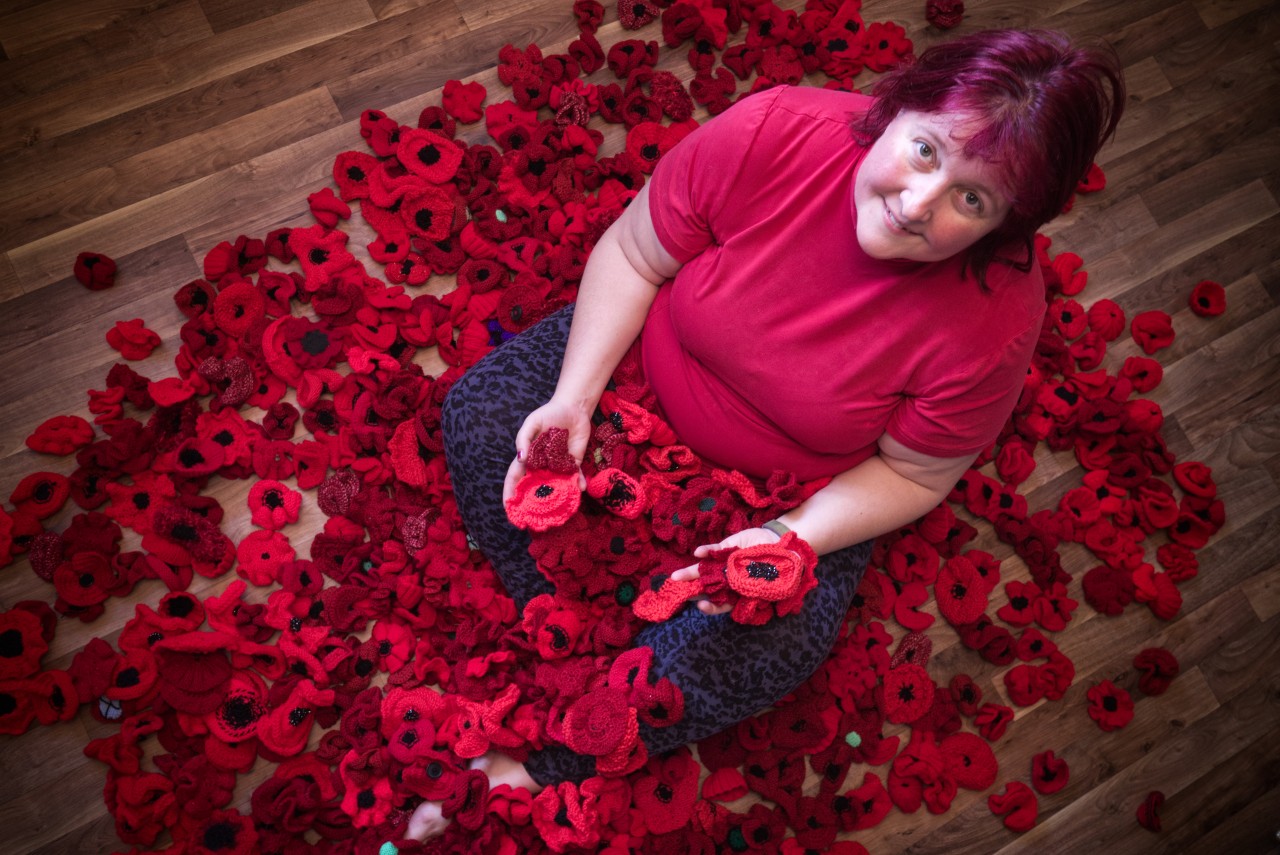 Rachel with just a small number of the poppies crafted by residents of Pennington