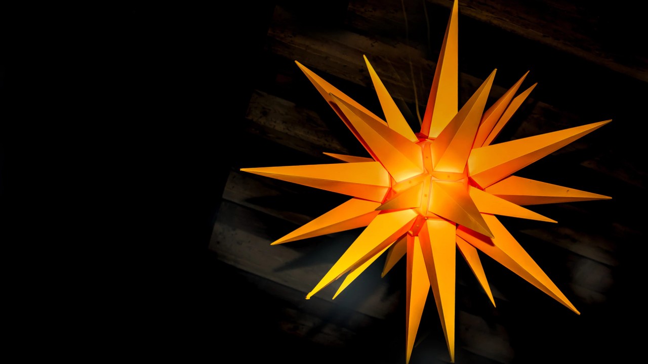 Orange lit star hung from ceiling