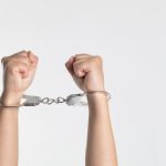 Hands held up in handcuffs