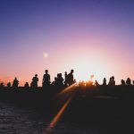 Group of people silhouette against sunrise